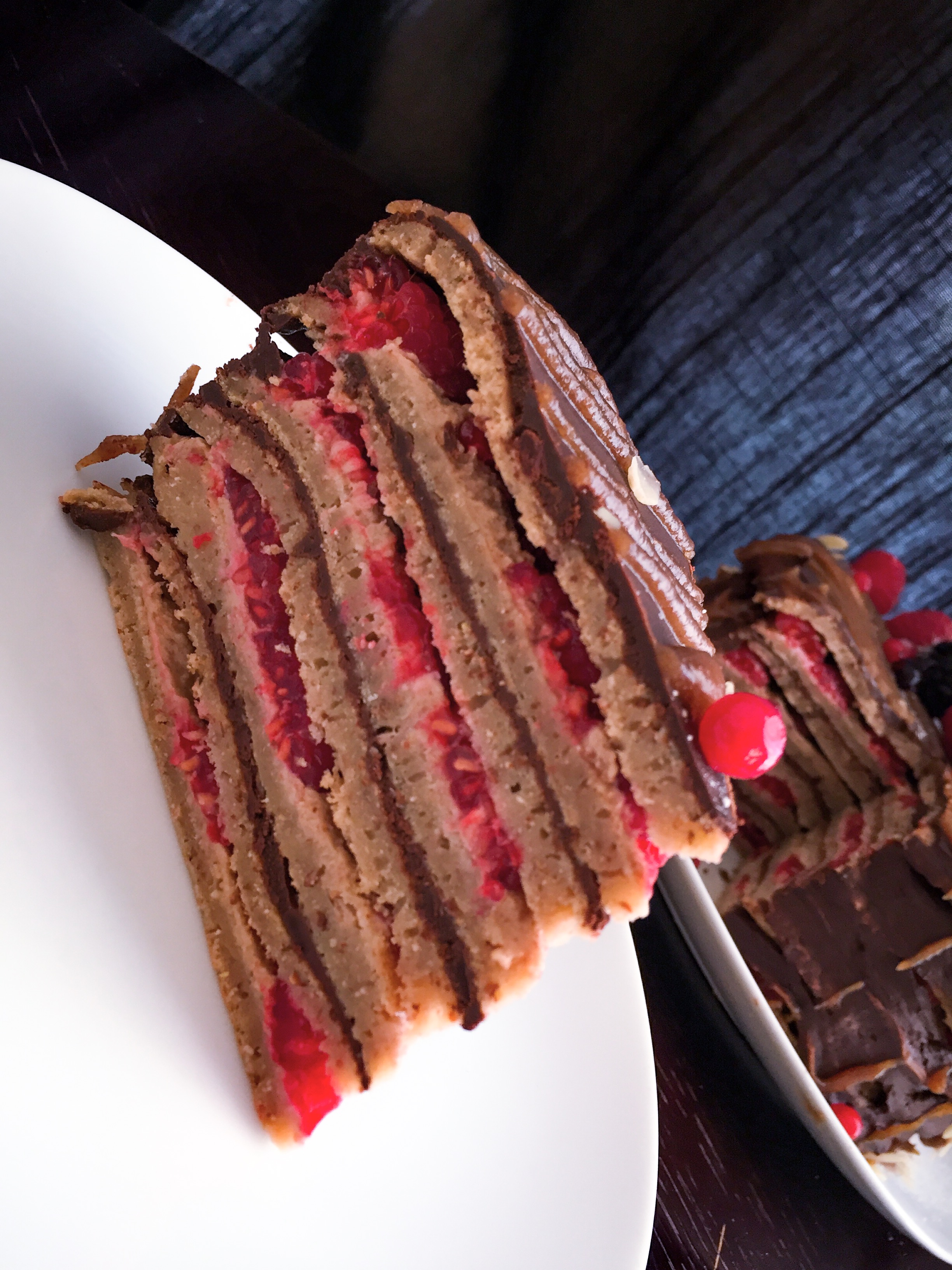 Chocolate and peanut butter pancake cake with raspberries